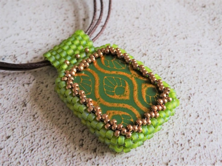 Polymer clay focal bead with beaded bezel