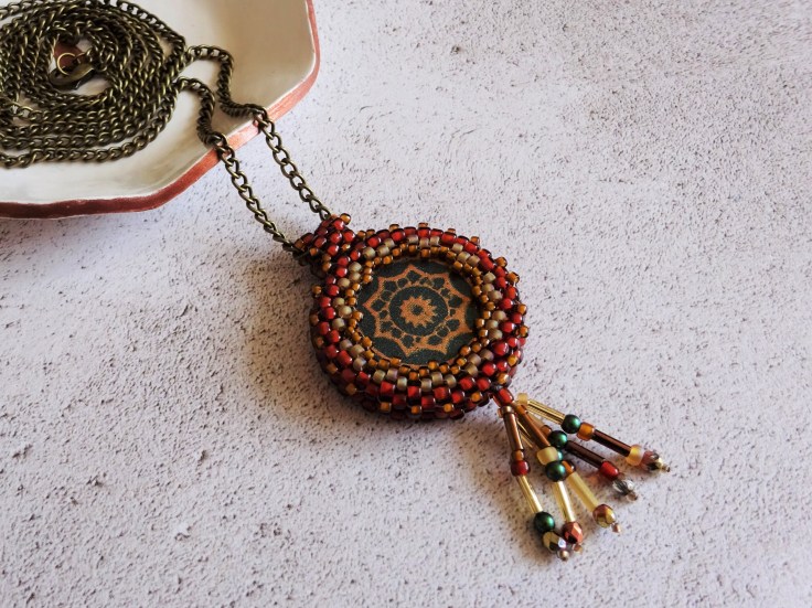 Polymer clay focal bead with beaded bezel