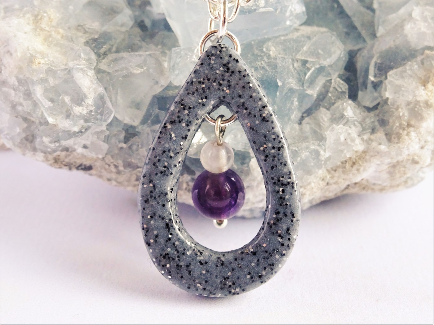 A teardrop necklace with amethyst beads
