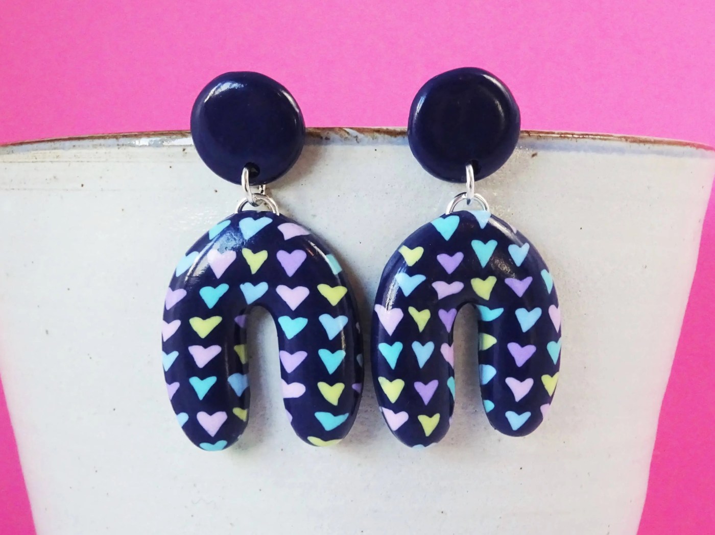 Statement multicolour heart earrings in navy blue and pastel coloured hearts