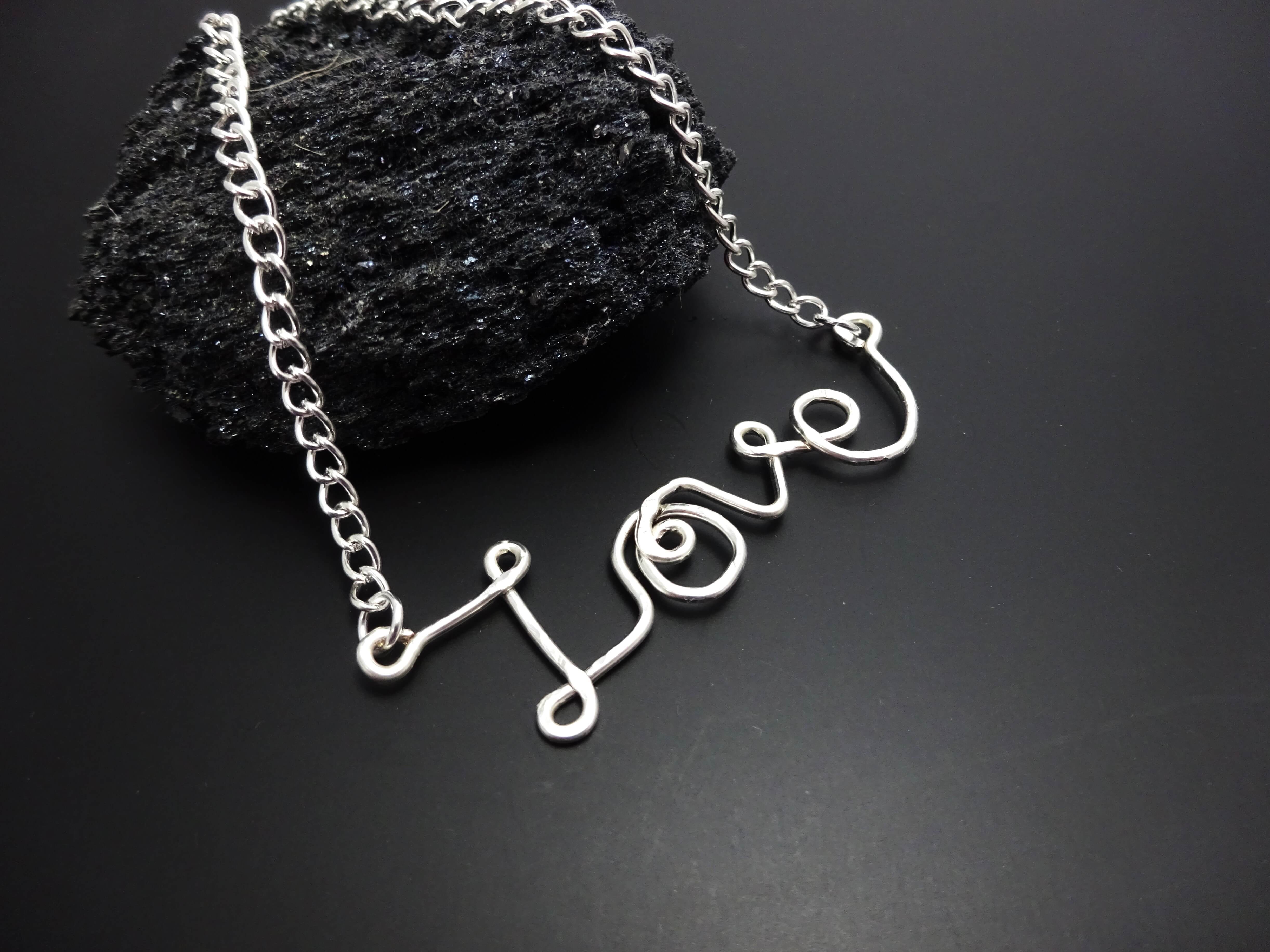 A silver 'Love' pendant necklace