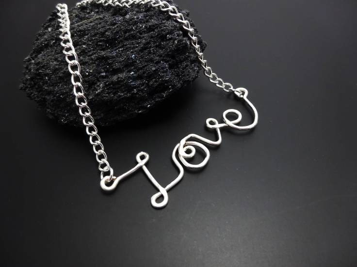 A silver 'Love' pendant necklace