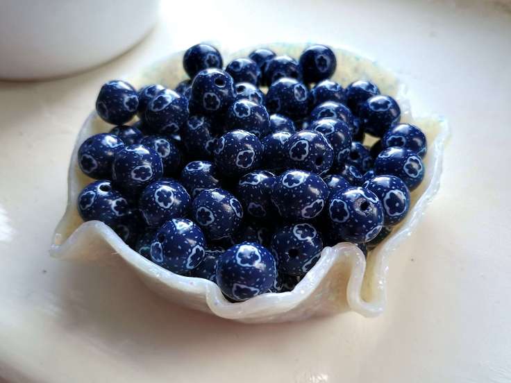 Handmade polymer clay beads with a floral and polka dot pattern