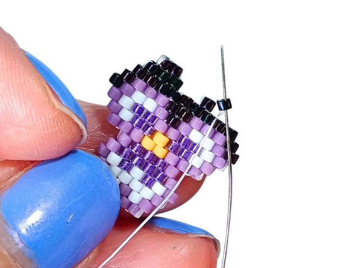 A brick stitch pansy being made