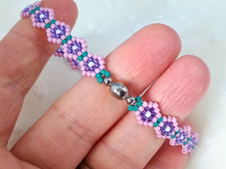 A close up of the clasp on the brick stitch flower pattern bracelet