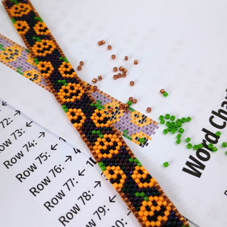 A peyote stitch pumpkin bracelet laying on it's pdf pattern.