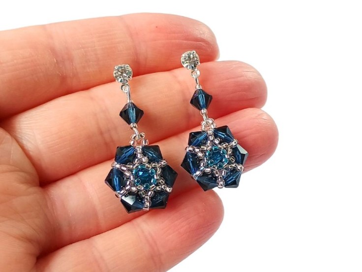 Bicone and seed bead earrings being held