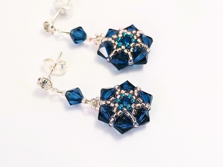 Close up of a pair of seed bead and bicone earrings