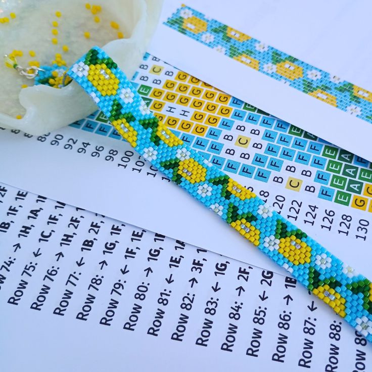 A peyote bracelet with a lemon design laid on the pdf pattern