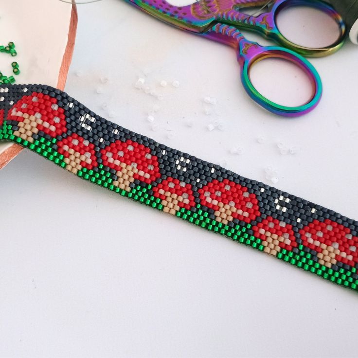 Mushroom peyote beaded bracelet against a white background